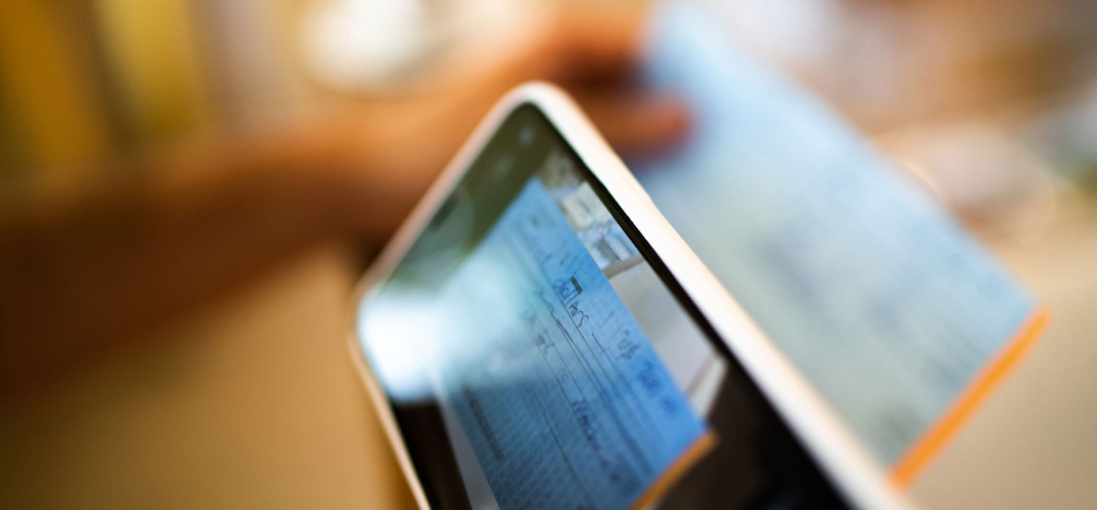 Person scanning a check with their phone and mobile app.