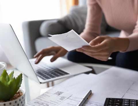 Person doing finances on a laptop.