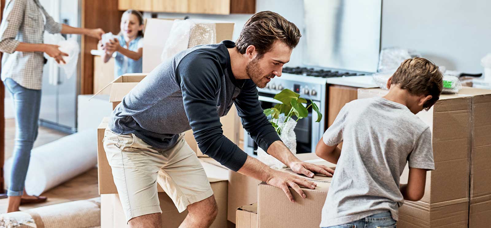 Family unpacking boxes in their new home.